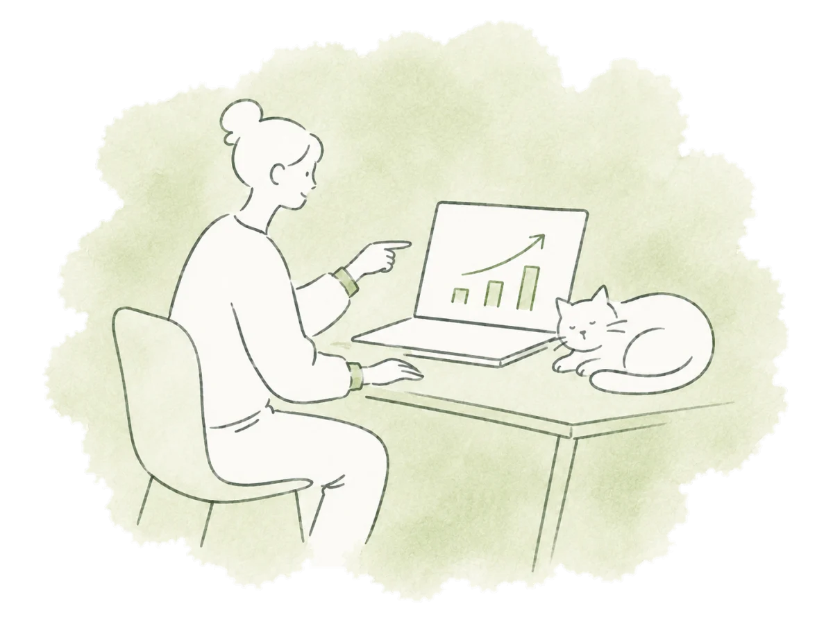 A volunteer reviews simple charts on a laptop beside a resting cat.