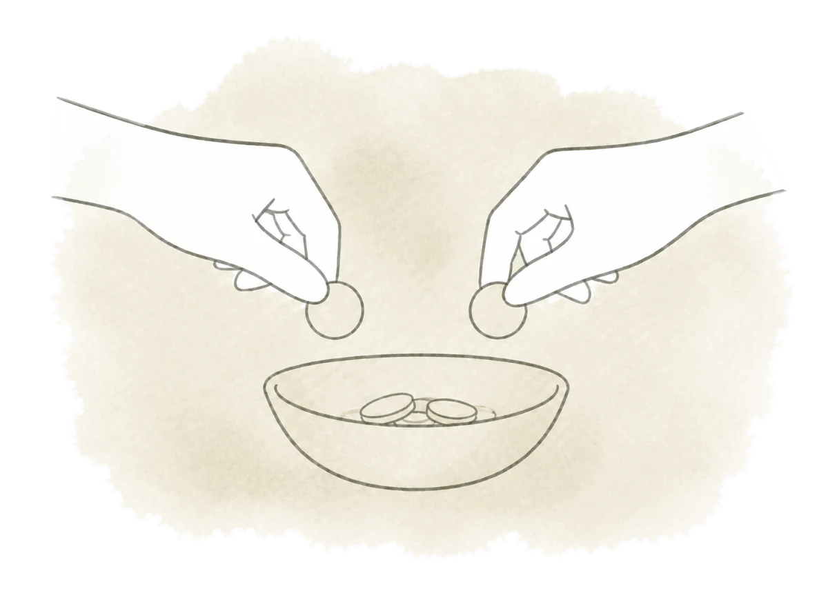 Two hands bring small contributions together in one bowl.