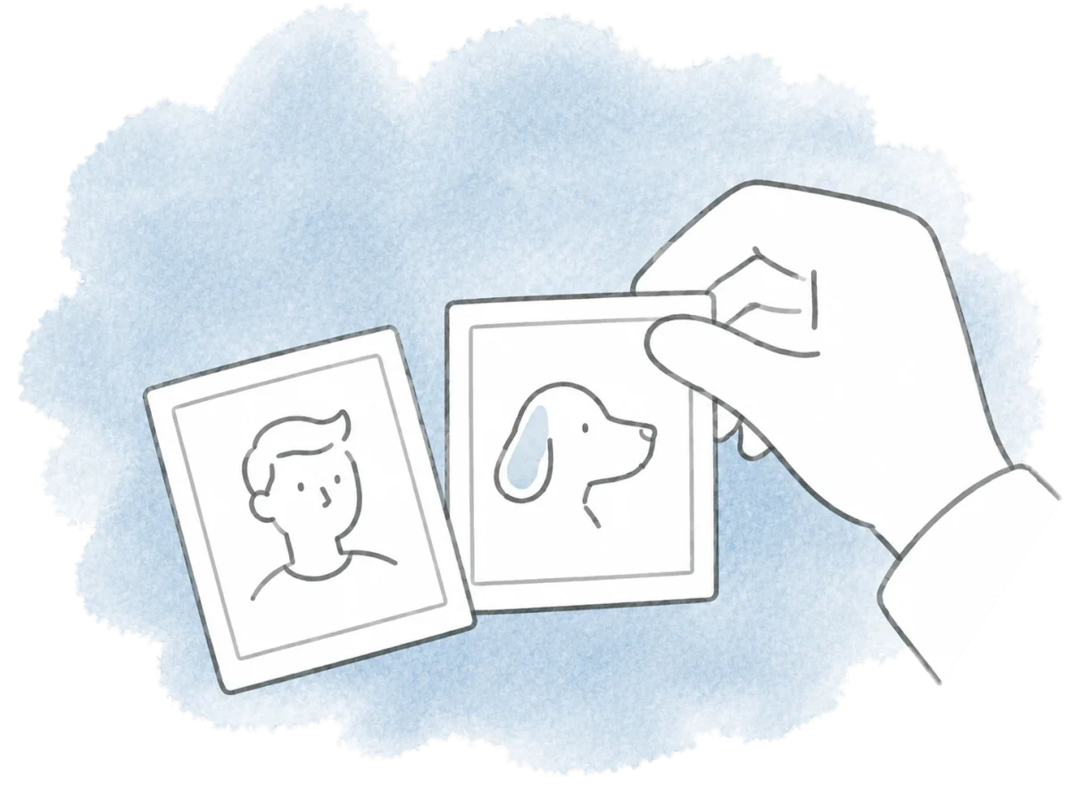 A person arranges a small portrait and an animal photo together.