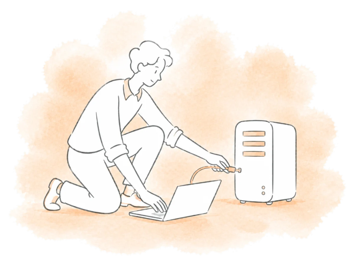 A technician connects a dedicated server to a laptop.
