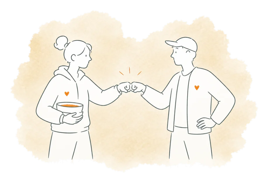 Two volunteers acknowledge a finished job with a fist bump.