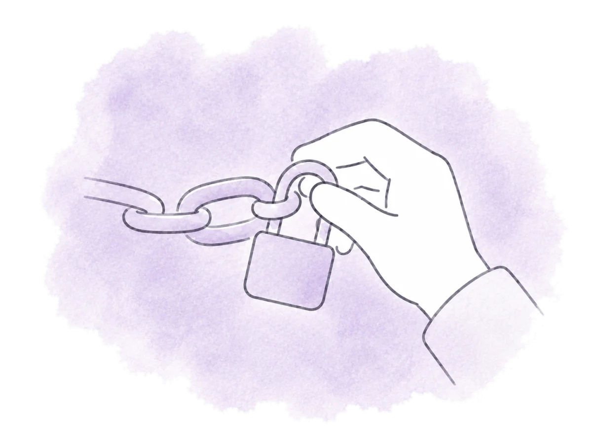A hand secures two chain links with a small padlock.