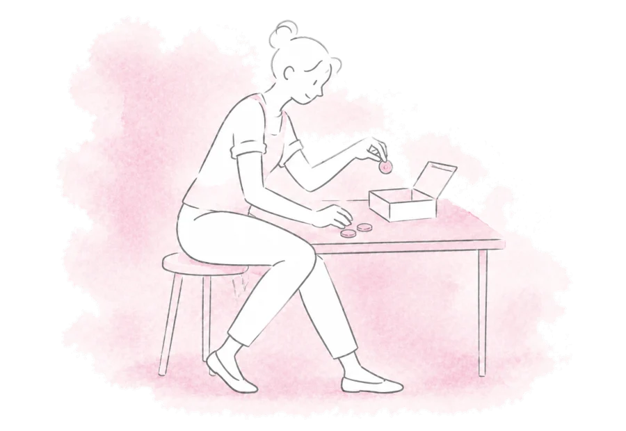 A treasurer sorts coins into a small cash box.